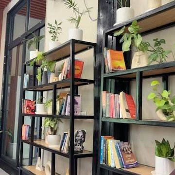 Metal-and-wood bookshelves with plants and books