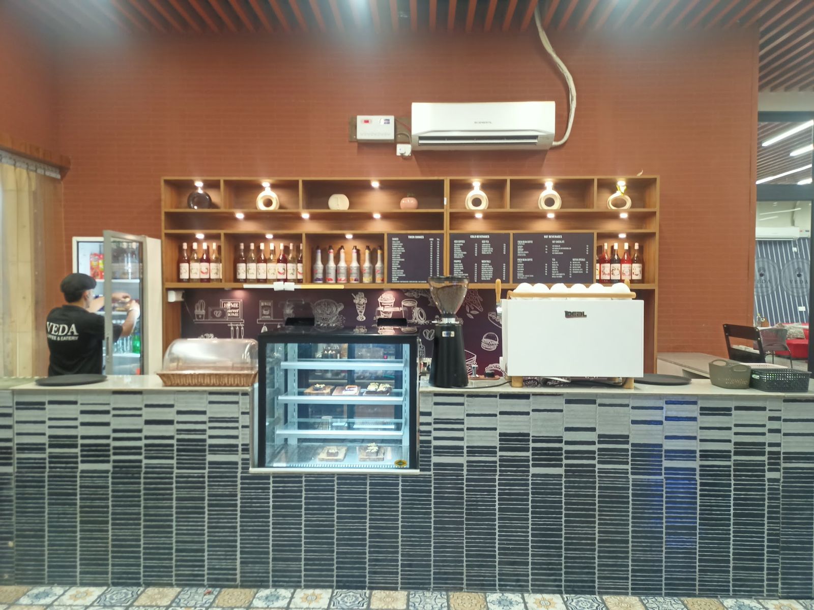 The coffee counter with espresso machine and cake display