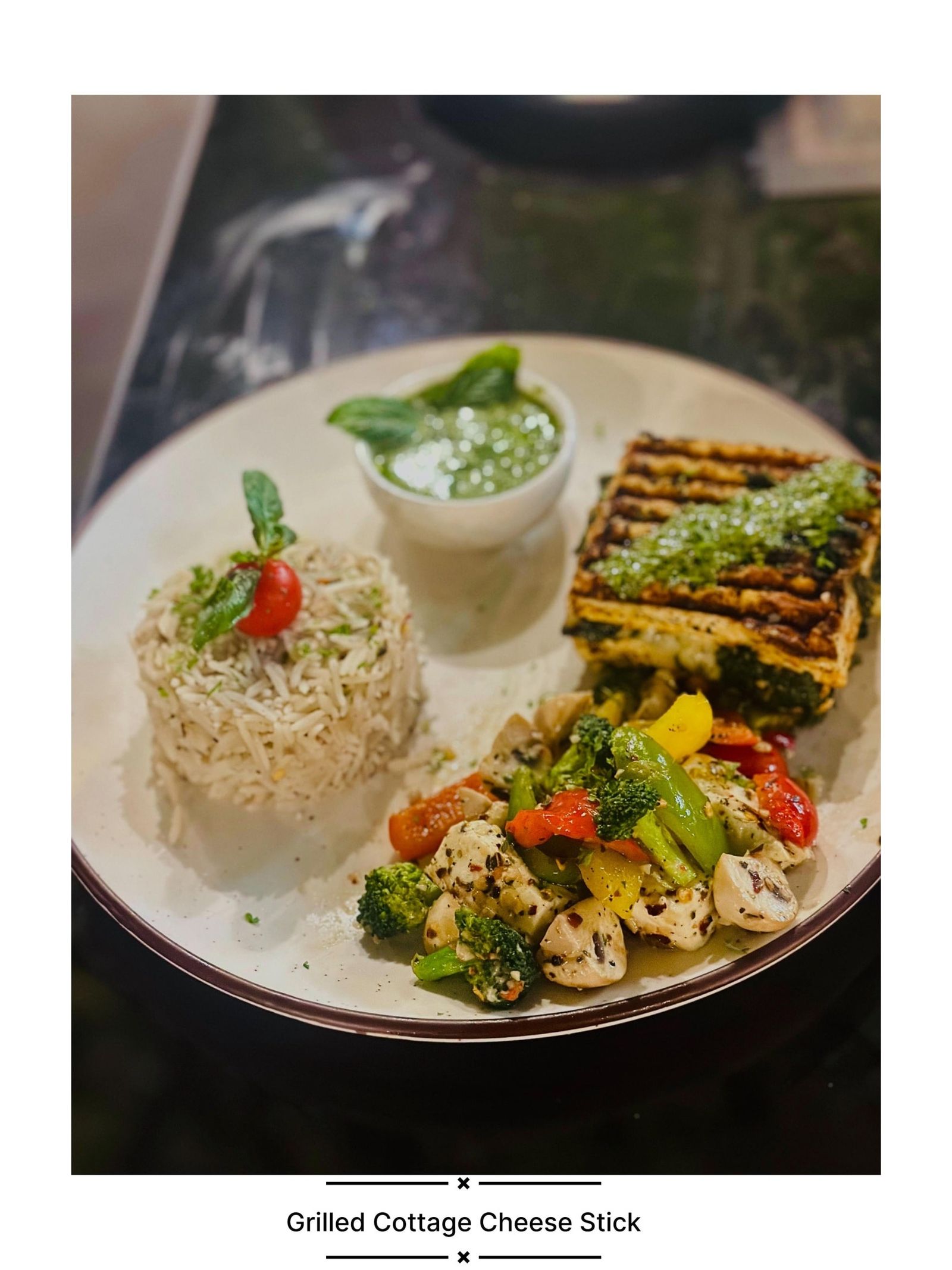 Grilled cottage cheese with mushroom rice, sautéed vegetables and pesto dip